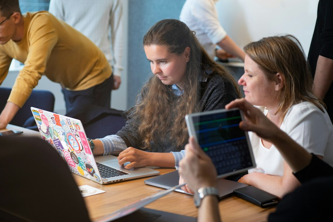 diverse students coding together