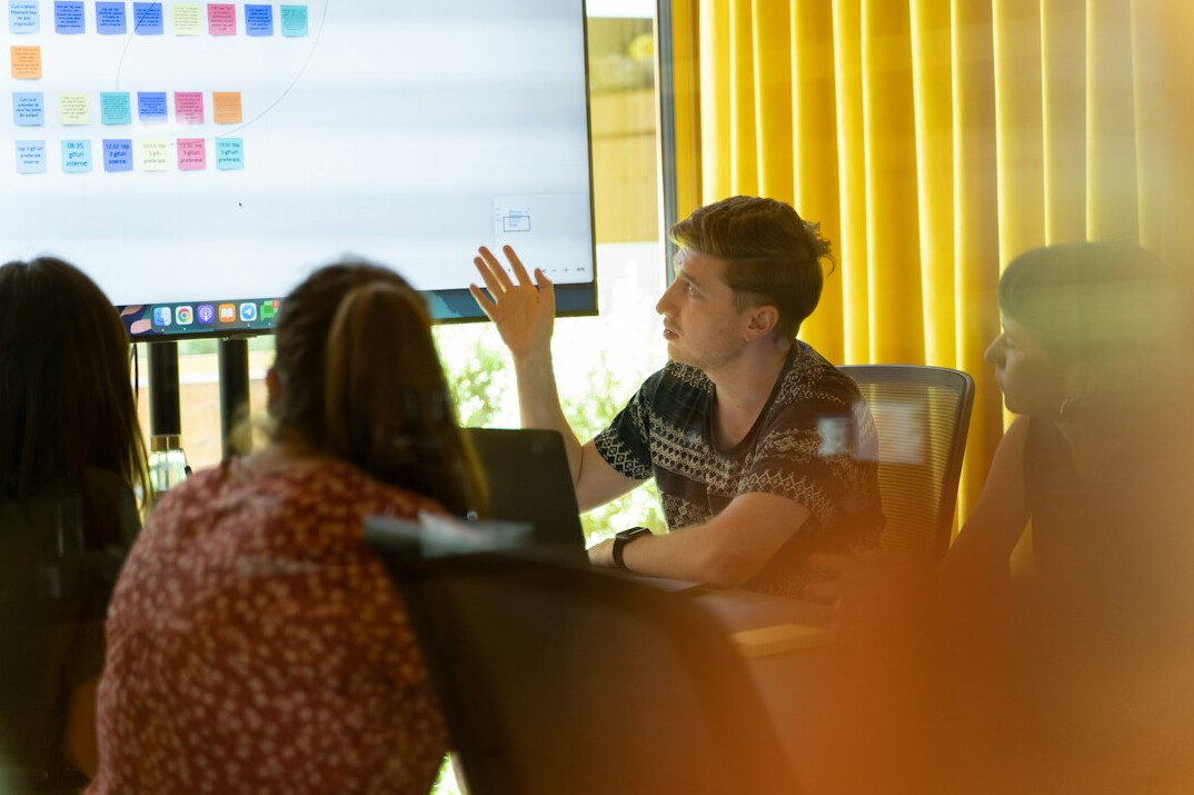 woman explaining code to group