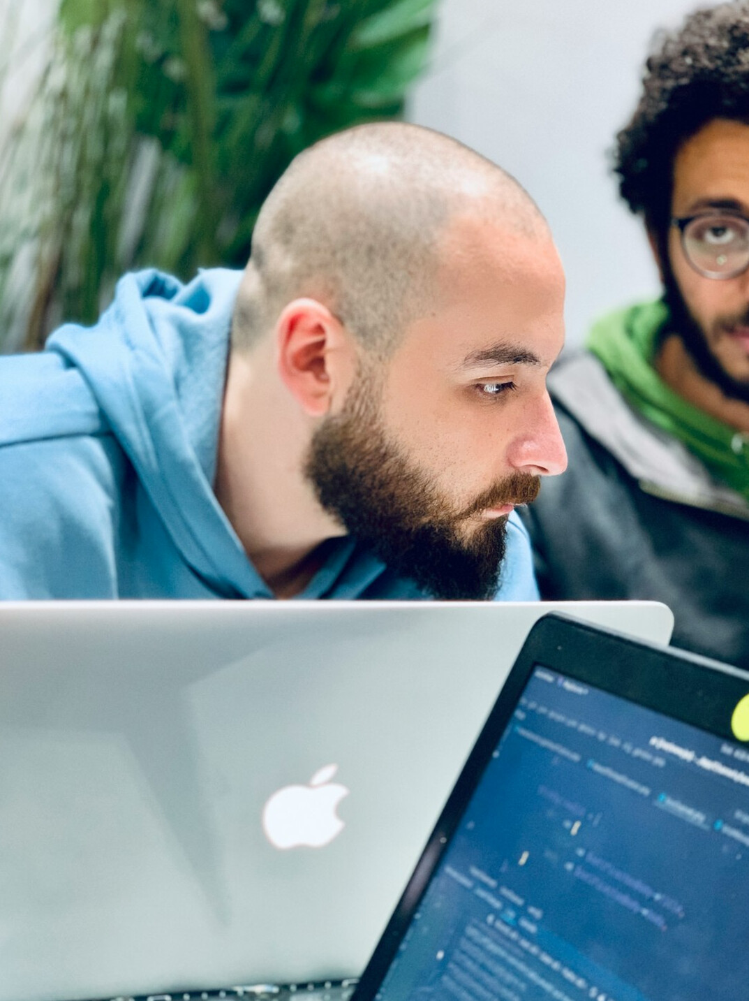 programmer coding on laptop